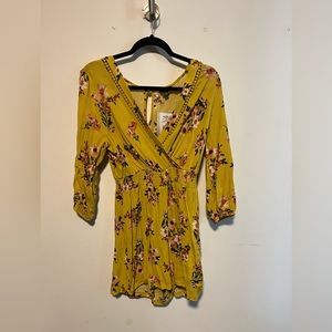 Long sleeve yellow romper with flowers! Size medium. Never worn with tags.
